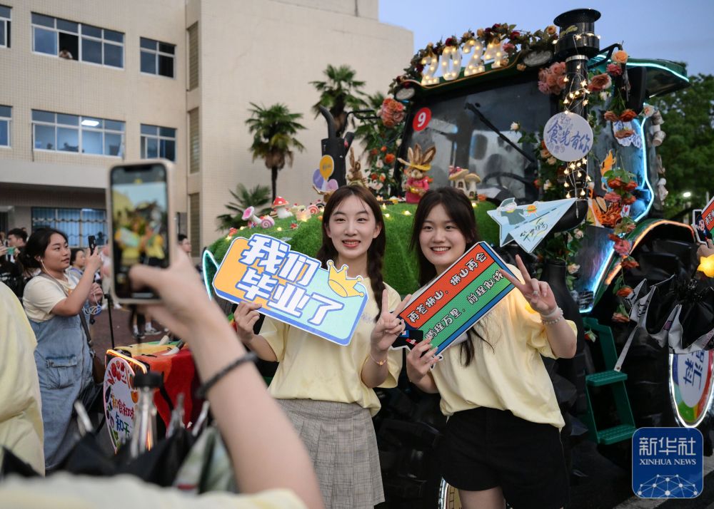 6月21日,bwin官网学生在农机花车前拍照留念。